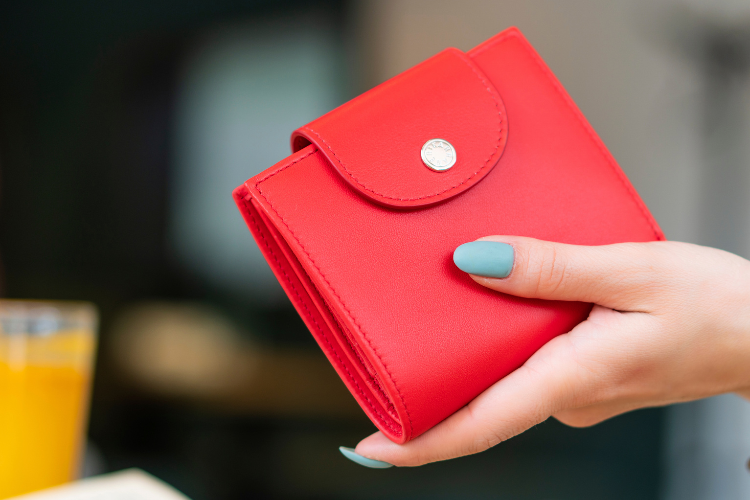 Close-Up Shot of a Person Holding a Red Wallet
